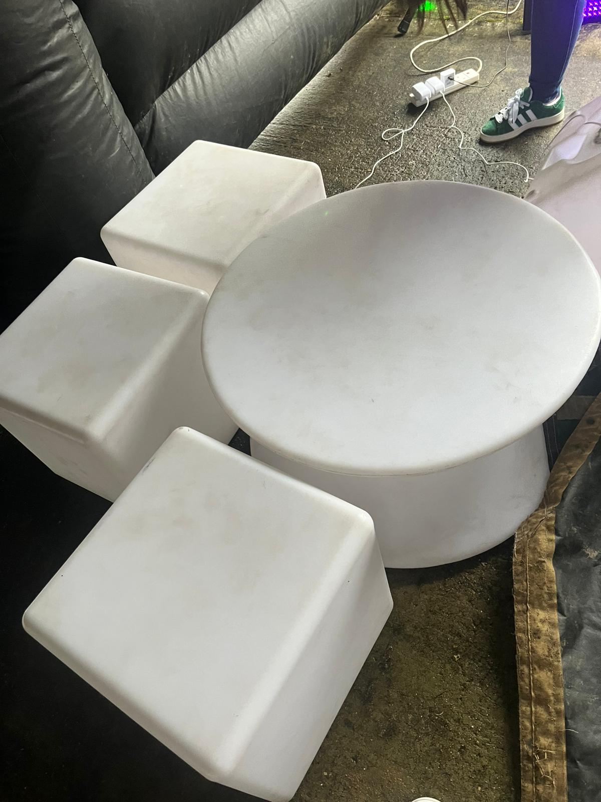 White seating and table included with inflatable night club hire package